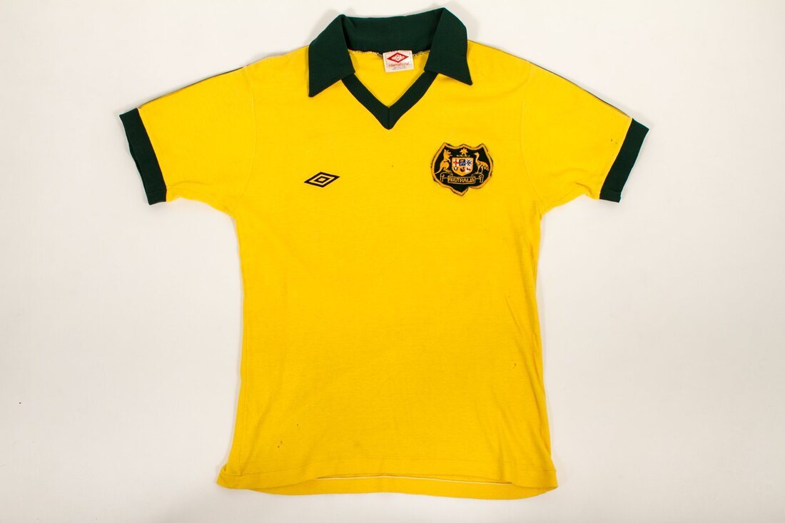 Peter Stone's gold 1977 Australia Socceroos home shirt with green collar